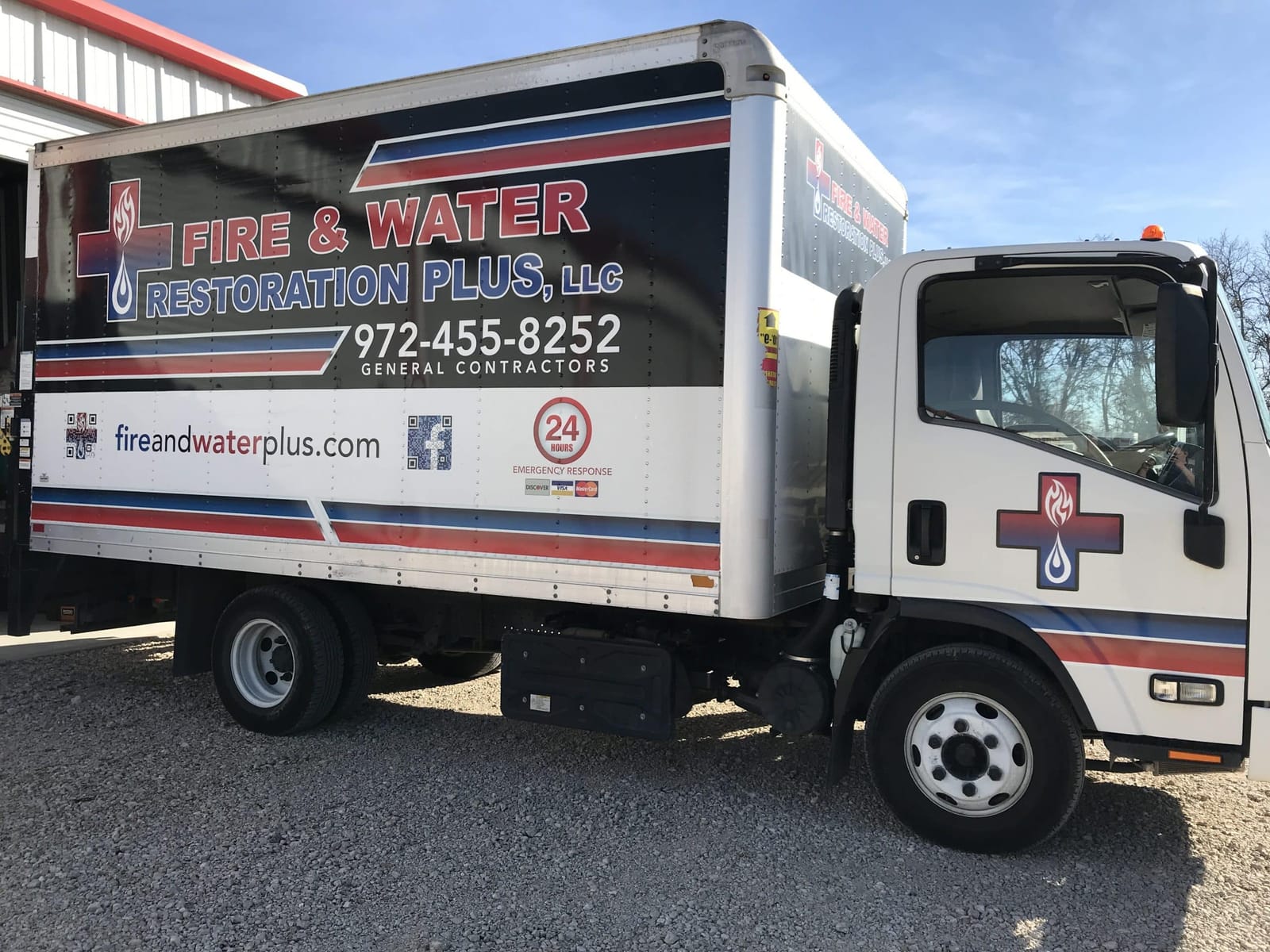 Fire & Water Restoration Plus box truck with the company logo and 24-hour emergency response phone number